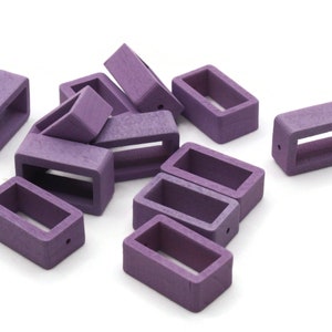 May include: A group of ten purple plastic watch strap buckle keepers. The buckles are rectangular with a small hole on one side.