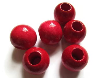 May include: Six bright red wooden beads with a hole in the center. The beads are round and smooth.