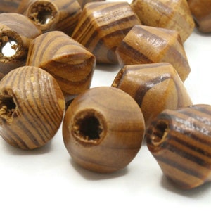 May include: A group of wooden beads with a brown and tan striped pattern. The beads are shaped like a diamond with a hole in the center.