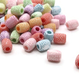 May include: A collection of colorful barrel-shaped beads in various pastel shades, including pink, orange, green, and blue. Each bead features a repeating geometric pattern and a hole running through the center, ideal for jewelry making or crafts.