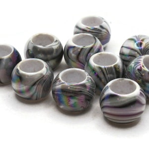 May include: A group of ten round, white beads with a black and iridescent swirl pattern. The beads are about 1 inch in diameter.