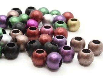 May include: A collection of round wooden beads in various colors, including gold, silver, black, green, purple, red, and brown. The beads have a metallic sheen and are arranged in a pile.