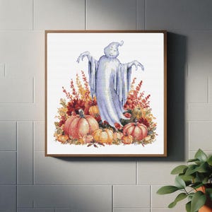 May include: A white ghost with a surprised expression stands in a field of fall foliage and pumpkins. The ghost is wearing a white sheet and has a surprised expression on its face. The pumpkins are orange and yellow and are surrounded by fall foliage in shades of red, orange, and yellow.
