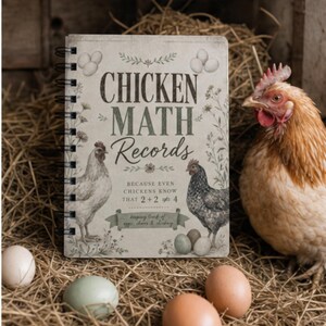 May include: A notebook titled "CHICKEN MATH Records" with illustrations of chickens and eggs. The notebook is spiral-bound and surrounded by hay and eggs, with a live chicken in the background. The text reads "Because even chickens know that 2+2=4".