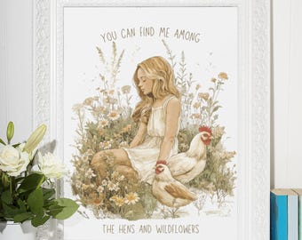 May include: A framed print with a watercolor illustration of a young woman sitting in a field of wildflowers with two chickens. The text "You can find me among the hens and wildflowers" is printed below the illustration.