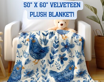 May include: A velour plush blanket with a blue bird and floral design, measuring 127cm x 152cm. The blanket has a cream background with blue birds, flowers, and foliage. The text "50" X 60" VELVETEEN PLUSH BLANKET!" is displayed at the top.