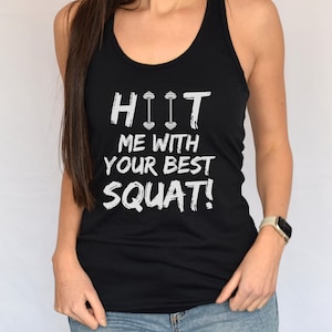 May include: Black tank top with white text that reads "HIIT ME WITH YOUR BEST SQUAT!" The text includes a dumbbell graphic.