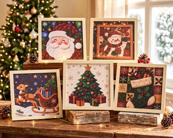 May include: Five square framed wall art pieces featuring Christmas themes including Santa Claus, a snowman, a reindeer pulling a sleigh, a decorated Christmas tree with gifts, and a holiday stocking, all displayed on a wooden surface.