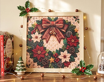 May include: A square framed wall art piece featuring a detailed illustration of a Christmas wreath with red and white poinsettias, pine cones, holly berries, and a large red patterned bow, set against a quilted beige background with stars.