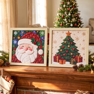 May include: Two square framed wall art pieces featuring quilted fabric designs. One displays a smiling Santa Claus with a red hat and holly, while the other shows a decorated Christmas tree with gold and red ornaments and wrapped gift boxes.