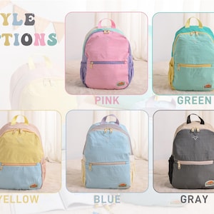 May include: The image showcases a selection of colorful backpacks. The backpacks come in pink, green, yellow, blue, and gray. Each backpack has a main compartment, a front pocket, and a top handle. The text "STYLE OPTIONS" is at the top.