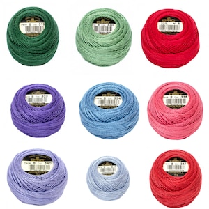 May include: Nine balls of DMC Perle Cotton thread in various colors, including green, red, blue, and purple. Each ball is labeled with a color number and weight of 10 grams.