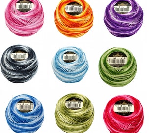 May include: Nine spools of DMC embroidery floss in various colors, including pink, orange, purple, black, blue, green, and red. Each spool is labeled with the DMC color number and the text "Perle 8 Col" and "COTON PERLE".
