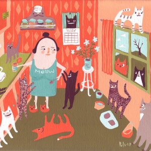 May include: A woman wearing a turquoise shirt with the word "MEOW" printed on it is surrounded by cats in a kitchen. The kitchen has orange walls, a coffee maker, and a window with red curtains. There is a calendar on the wall that says "MAY".