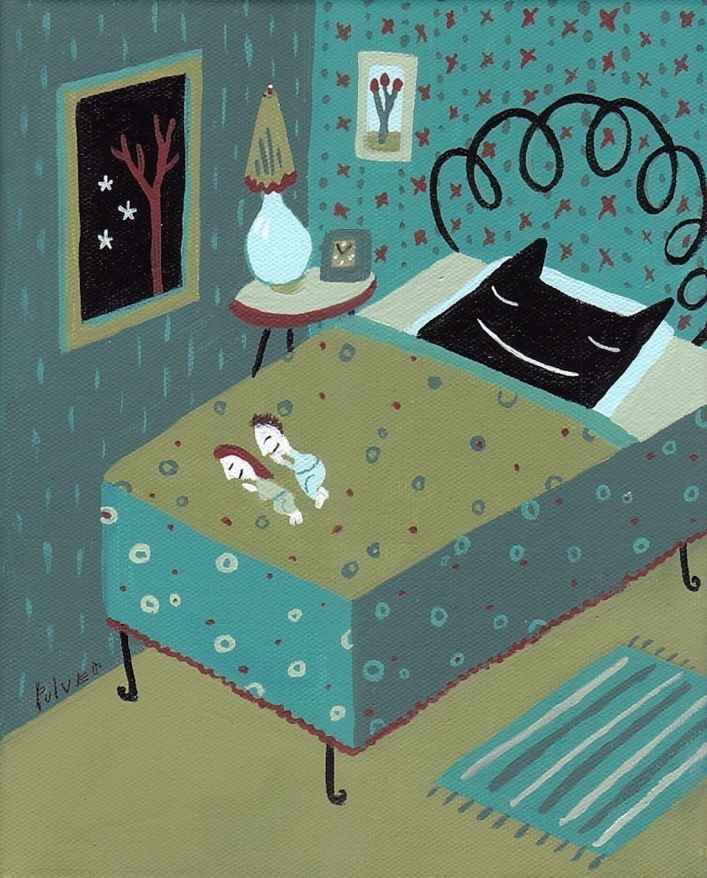 May include: A teal blue bed with a black cat sleeping on it. The bed has a green and brown patterned comforter and a white lamp on a small table next to it. There is a framed picture on the wall behind the bed.