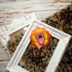 Toothy flower brooch from polymer clay