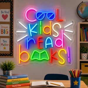 May include: A multi-colored neon sign mounted on a clear acrylic backing featuring the text Cool Kids Read Books with a pair of glasses icon replacing the double O in Cool and an open book icon replacing the double O in Books in bright neon tubing.