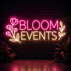 May include: A neon sign with the words "BLOOM EVENTS" in pink and yellow. The sign is decorated with floral and leaf designs. The sign is mounted on a dark brick wall, with plants in the foreground.