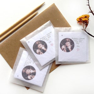 May include: Three white gift tags with a photo of Russell Crowe knitting. The text on the tags reads "Russell Crowe didn't knit this one but I did".