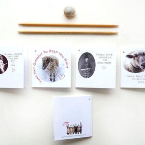 May include: Four white cards with black and white images and red text. The text on the cards reads "Hand Knit Garment to Keep You Warm", "Russell Crowe didn't knit this one but I did", "From one hipster to another", and "Hand Knit Garment to Keep You Warm".
