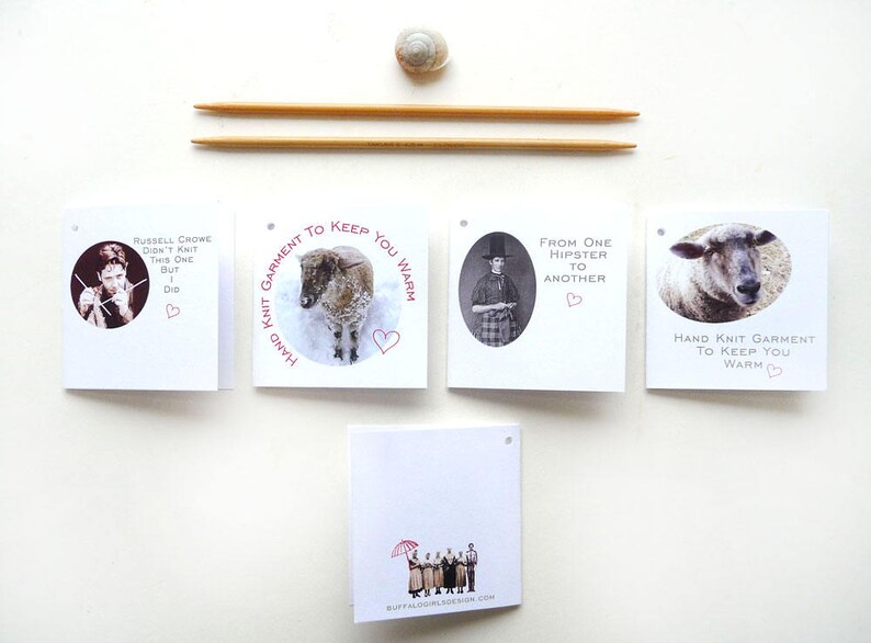 May include: Four white cards with black and white images and red text. The text on the cards reads "Hand Knit Garment to Keep You Warm", "Russell Crowe didn't knit this one but I did", "From one hipster to another", and "Hand Knit Garment to Keep You Warm".