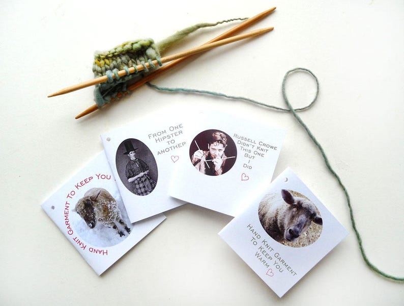 May include: Four white cards with black and white images and text. The text on the cards reads "Hand Knit Garment to Keep You Warm", "From One Hipster to Another", "Hand Knit Garment to Keep You Warm", and "Russell Crowe Didn't Knit This One But I Did".