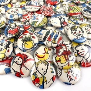 May include: A collection of vintage-style round buttons with colorful illustrations. The buttons feature images of children, women, and various objects in a retro aesthetic. The designs include figures, ducks, and text, with a mix of red, blue, yellow, and white.