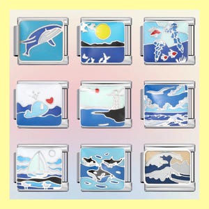 Könnte beinhalten: Neun Charms mit Ozeanmotiven und silberfarbenen Metallrahmen. Designs umfassen einen Wal, Sonne über dem Meer, Quallen, Wal mit Herz, Leuchtturm, Meereswellen, Segelboot, Orcas und eine große Welle. Jeder Charm ist quadratisch und hat Emaille-Details.