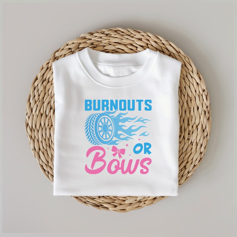 May include: White t-shirt with a blue tire and flames graphic and the text "Burnouts or Bows" in pink and blue.
