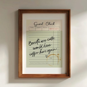 May include: A framed print of a vintage-style guest check with handwritten text that reads "Barista was cute, would have coffee here again." The check has a brown coffee stain and a heart drawn next to the text "TAX".