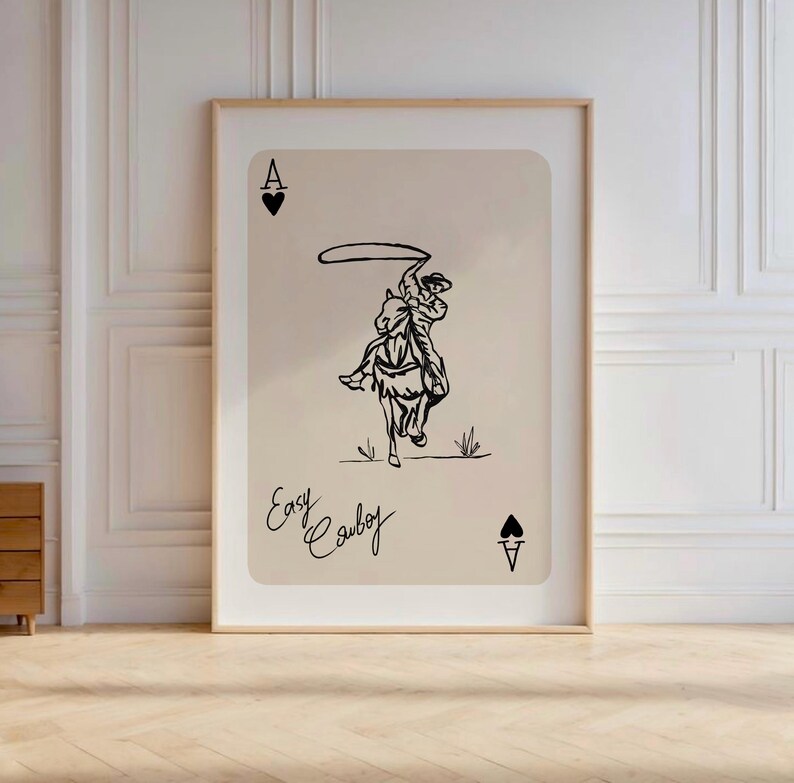 May include: A black and white illustration of a cowboy riding a horse and lassoing. The image is on a beige background with the text "Easy Cowboy" and the Ace of Spades card symbol.