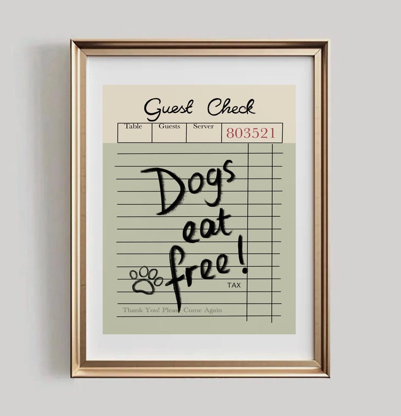 May include: Framed print featuring a "Guest Check" design with the text "Dogs eat free!" in a handwritten style. The print includes a paw print and the phrase "Thank You! Please Come Again."