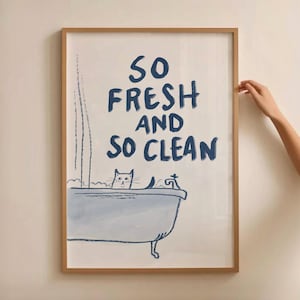 May include: A framed print with a blue and white illustration of a cat in a bathtub with the text "So Fresh and So Clean".