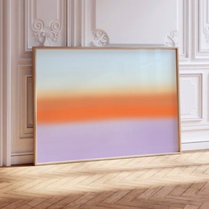 Puede incluir: Una impresión de arte abstracto enmarcada con un degradado de colores, comenzando con un azul claro en la parte superior, pasando a un amarillo pálido, luego a un naranja brillante y finalmente a un morado claro en la parte inferior.