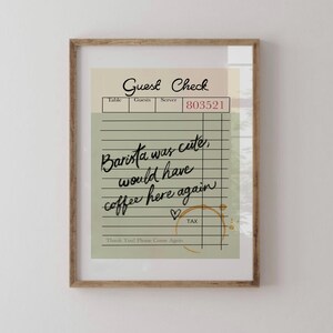 May include: A green and white guest check with the text "Guest Check" at the top. The check has a handwritten message that says "Barista was cute, would have coffee here again" with a heart drawn next to it. The check has a brown coffee stain.