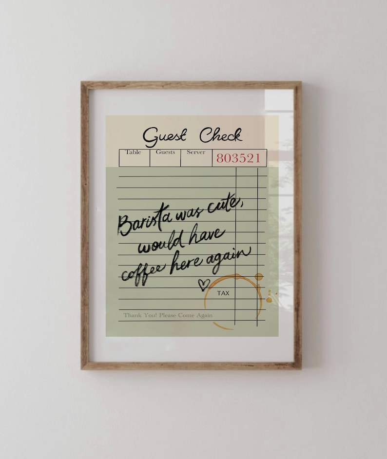 May include: A green and white guest check with the text "Guest Check" at the top. The check has a handwritten message that says "Barista was cute, would have coffee here again" with a heart drawn next to it. The check has a brown coffee stain.