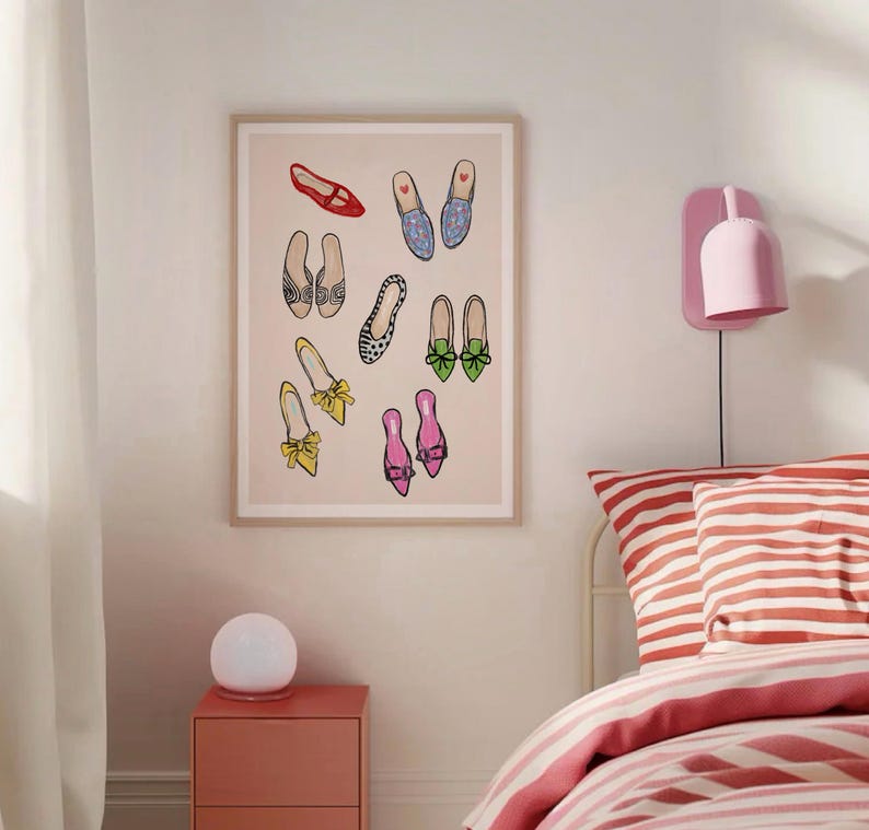 May include: A framed print of a collection of colorful shoes with different patterns and styles. The shoes are arranged in a random pattern on a light pink background.