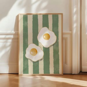 May include: Two fried eggs with golden yolks on a green and white striped background. The eggs are stylized and have a retro feel.