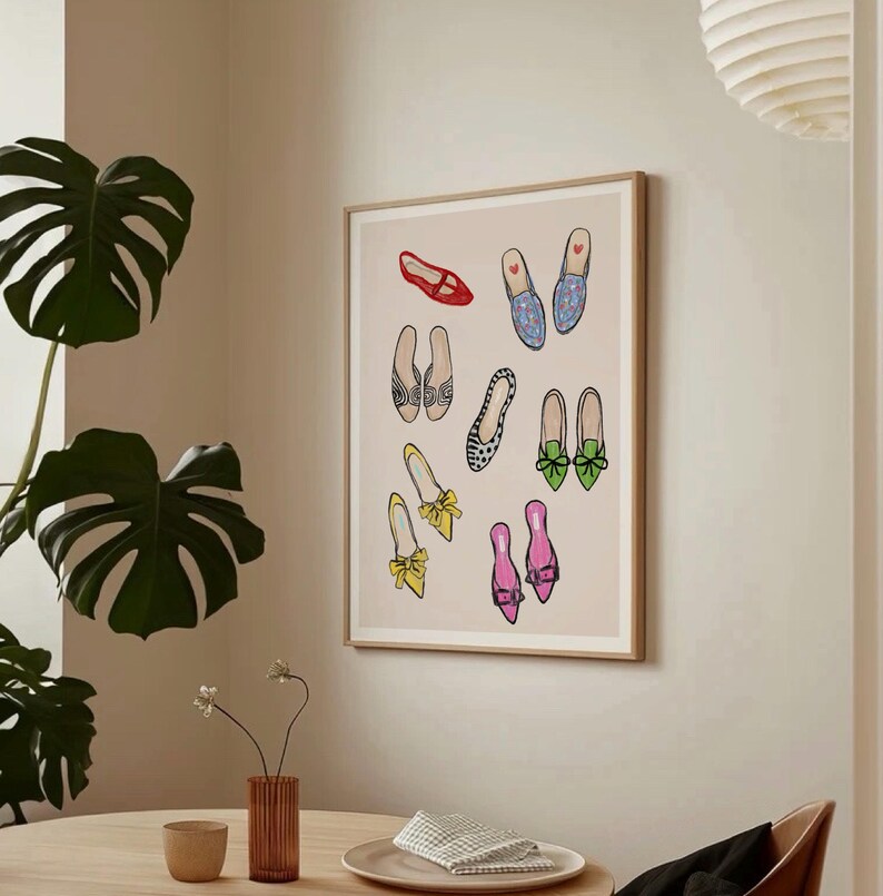 May include: A framed print featuring a collection of colorful and patterned shoes. The shoes are arranged in a whimsical pattern on a light pink background.