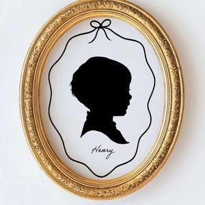 May include: A black silhouette of a child's profile in a gold oval frame with the name "Henry" written below.