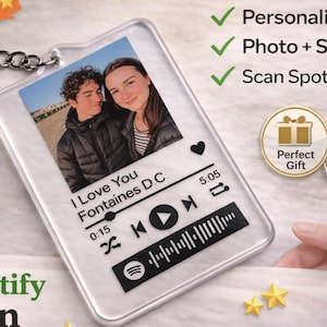 May include: Personalised acrylic Spotify keychain with a photo and song details. The keychain features a photo of a couple, song title, and a Spotify code. Includes a metal keyring and a Made in UK badge.