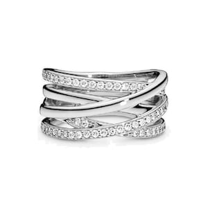 May include: A silver ring with multiple bands that are intertwined and set with small clear stones.