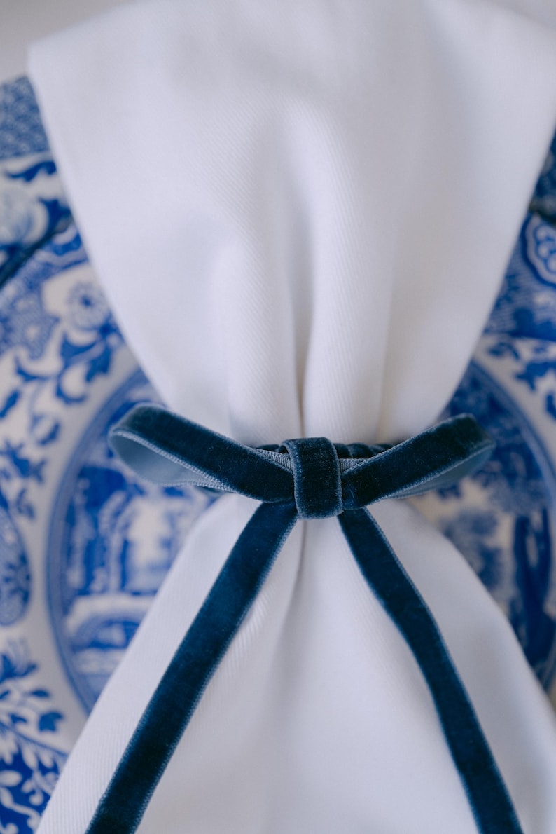 Blue, thin bow napkin rings in a Christmas table setting.
