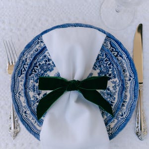Blue, bow napkin rings in a Christmas table setting of blue Tonkin plates.