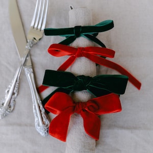 Multiple color, bow napkin rings in a Christmas table setting.