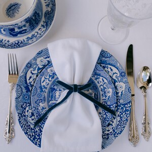 Blue, bow napkin rings in a Christmas table setting of blue italian plates.