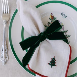 Green, bow napkin rings in a Christmas table setting.
