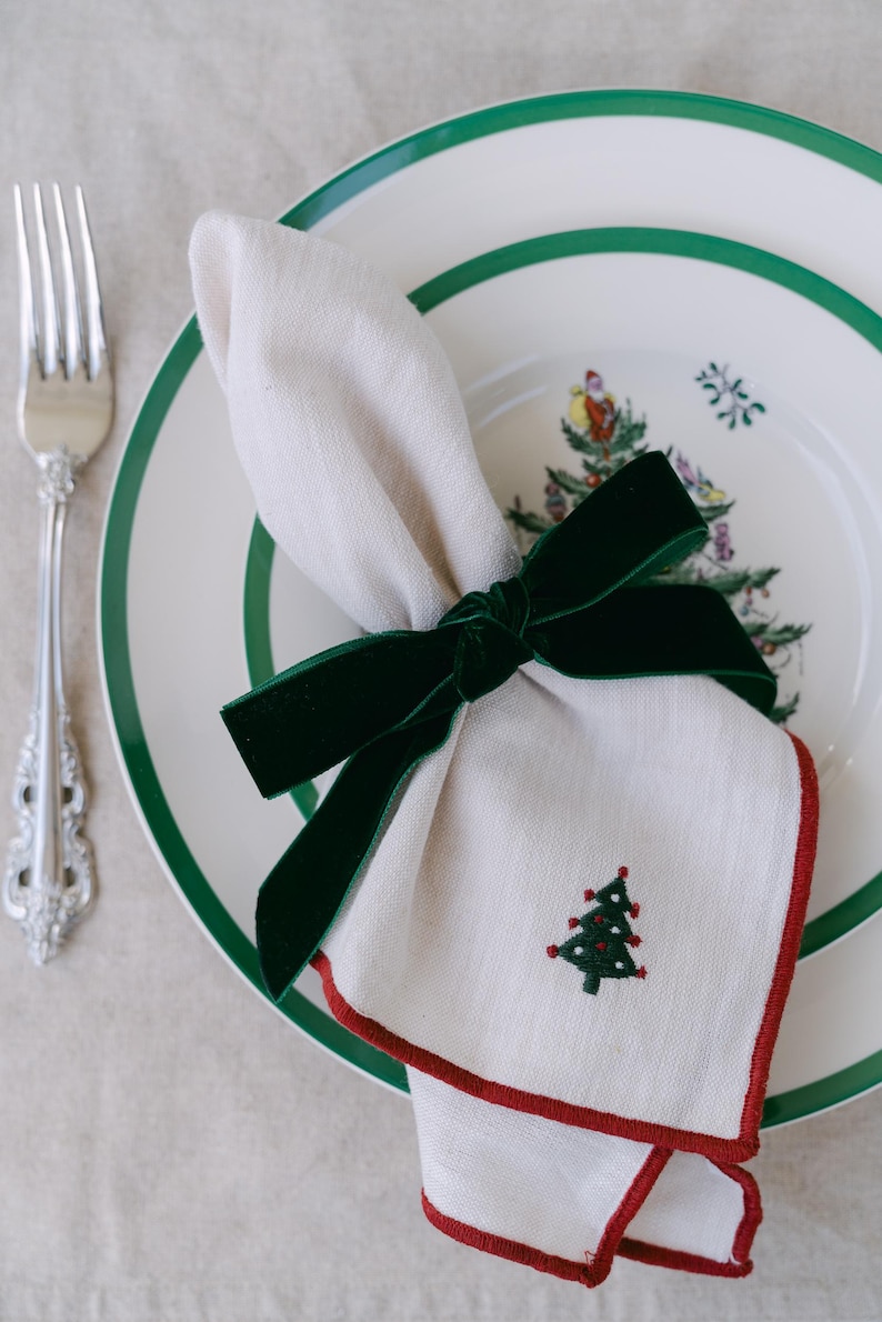 Green, bow napkin rings in a Christmas table setting.