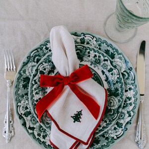 Red, bow napkin rings in a Christmas table setting.