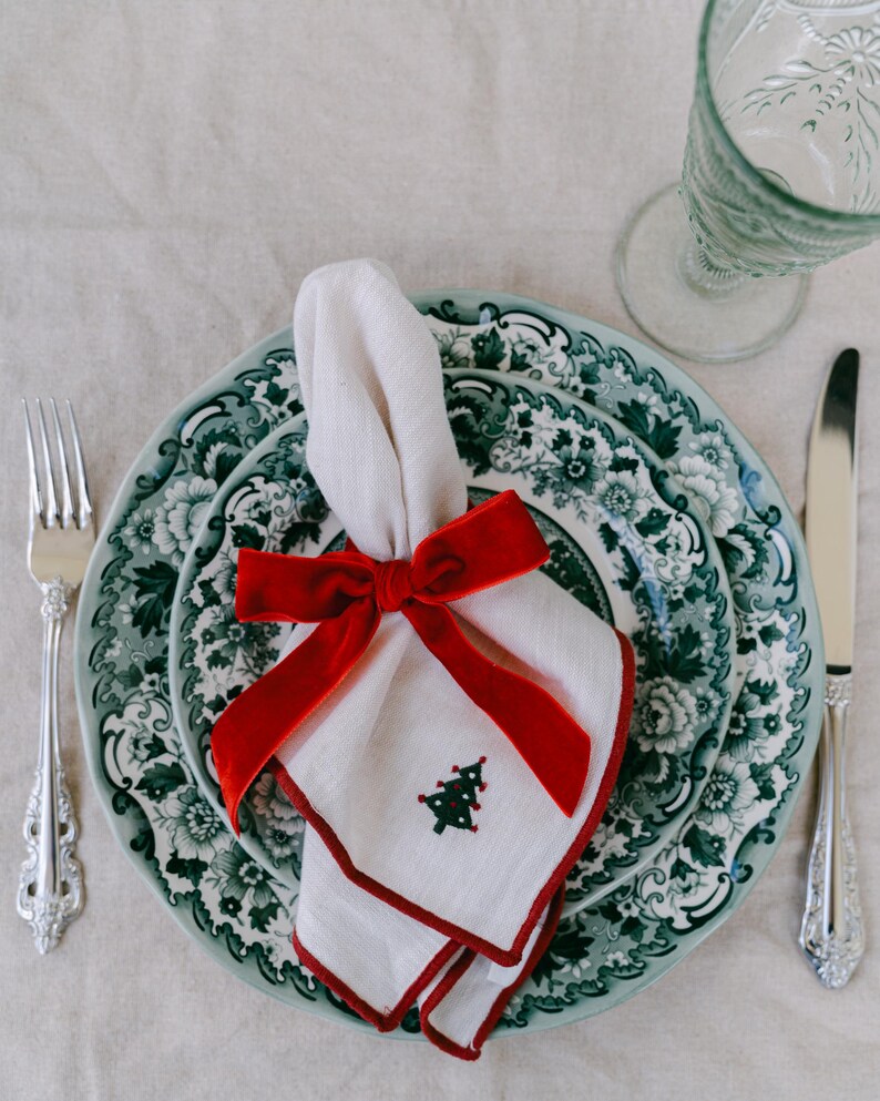 Red, bow napkin rings in a Christmas table setting.